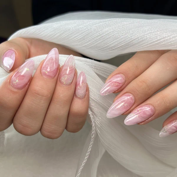 woman's hand with marble nail design