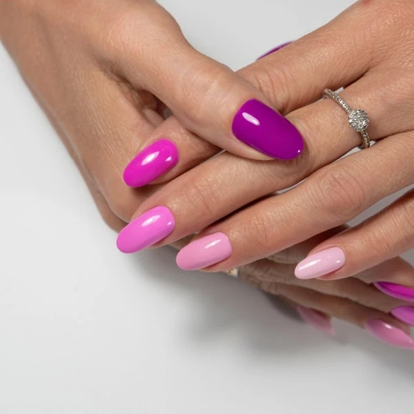 female hands with mismatched multi-colored nails