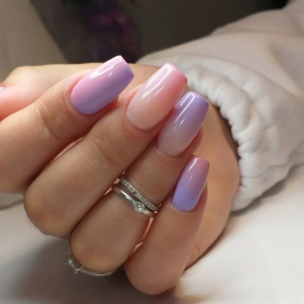 female hand with lilac and pink gradient ombre nails