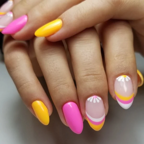 female hands with bright pink and citrus-colored floral nails