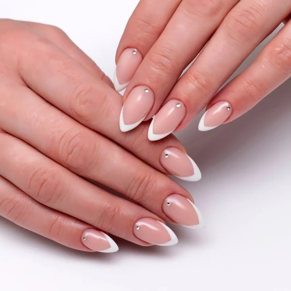 female hands with french manicure and crystals