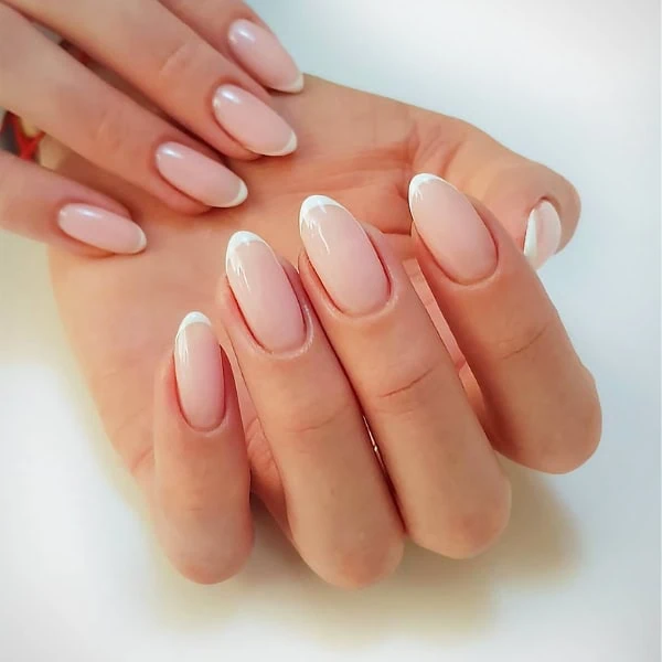 female hands with french micro-tip nails