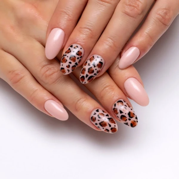 female hands with leopard manicure