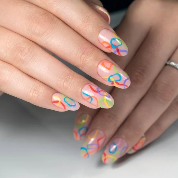 female hands with bright colorful abstract summer nails