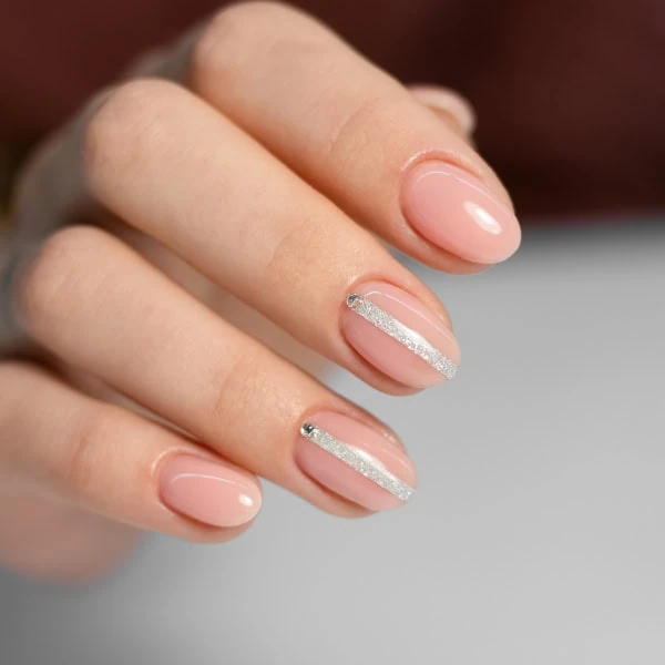 female hand with pink minimalist nails