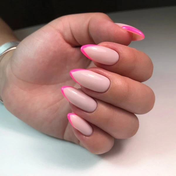 female hand with pink micro-tip nails