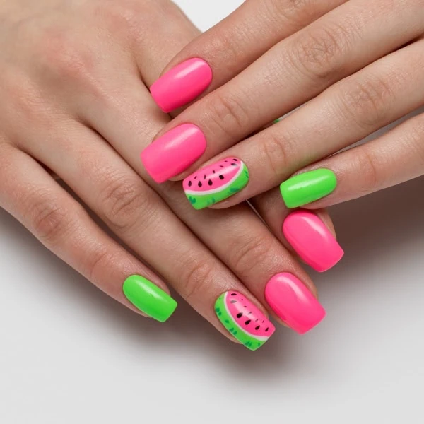 female hands with watermelon nail art