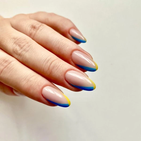 female hand with colorful micro-tip nail trend