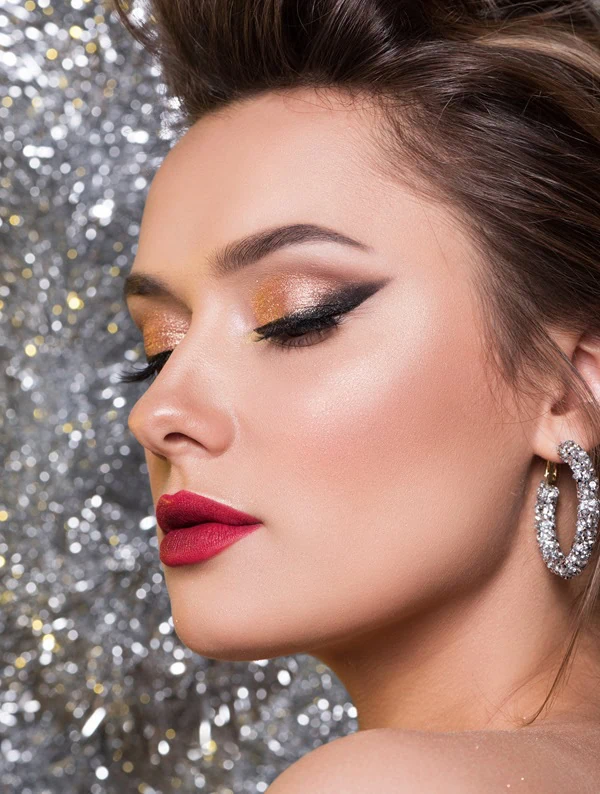 woman with red lips and shimmery eyeshadow for a christmas makeup look example