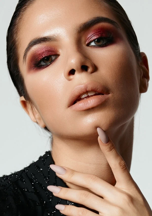 woman with a dark cherry colorful smokey eye makeup look