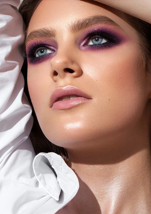 woman with colorful purple smokey eye makeup