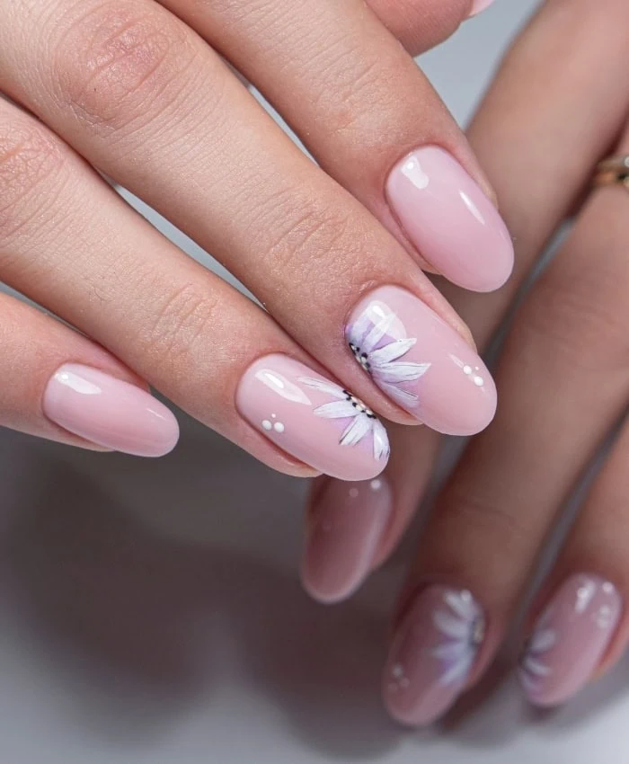 nails with soft pink polish and floral design for spring	