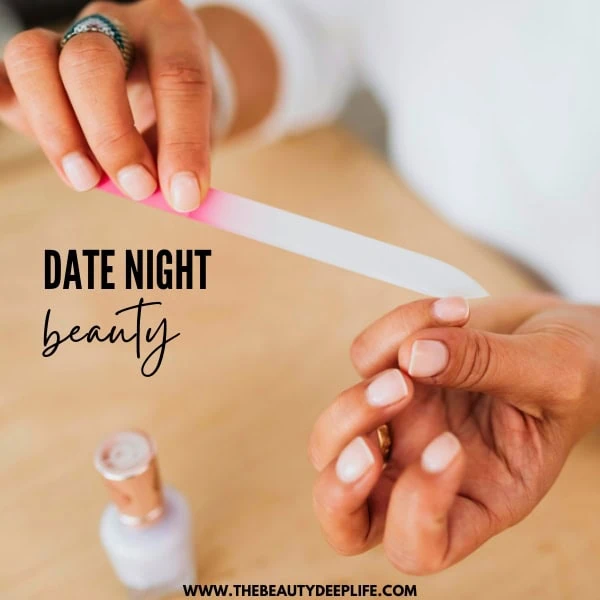 woman's hands as she files her nails and preps for date night 