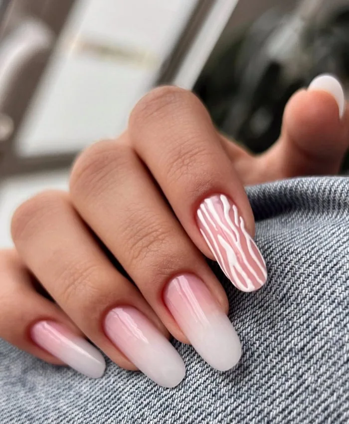 french ombre nails with zebra print on one nail