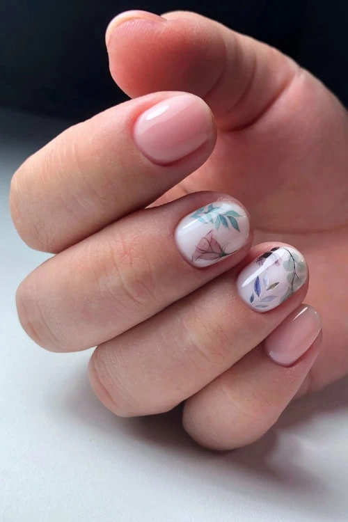 female hand with springtime floral nails with other nudes nails