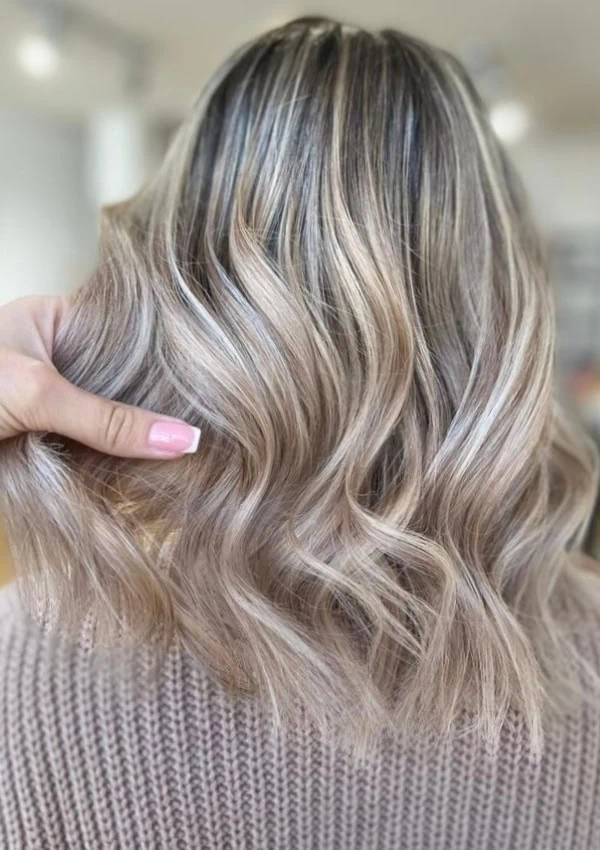 the back of a woman's head with tousled ash blonde hair