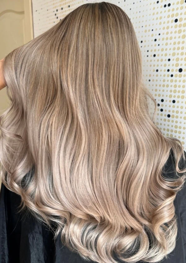back of a woman's head with long beige blonde hair color