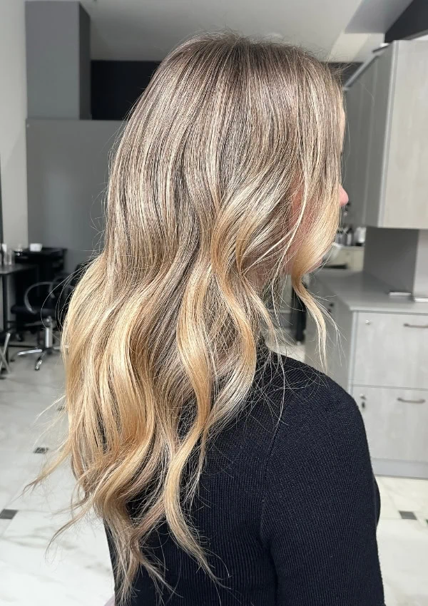 side profile view of a woman with lived in blonde hair
