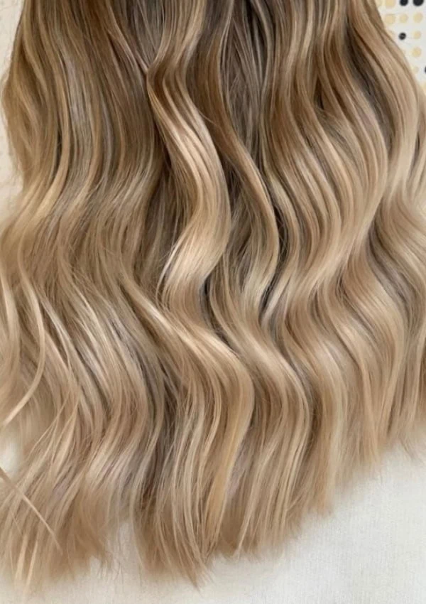 the back of a woman's head with sandy blonde hair