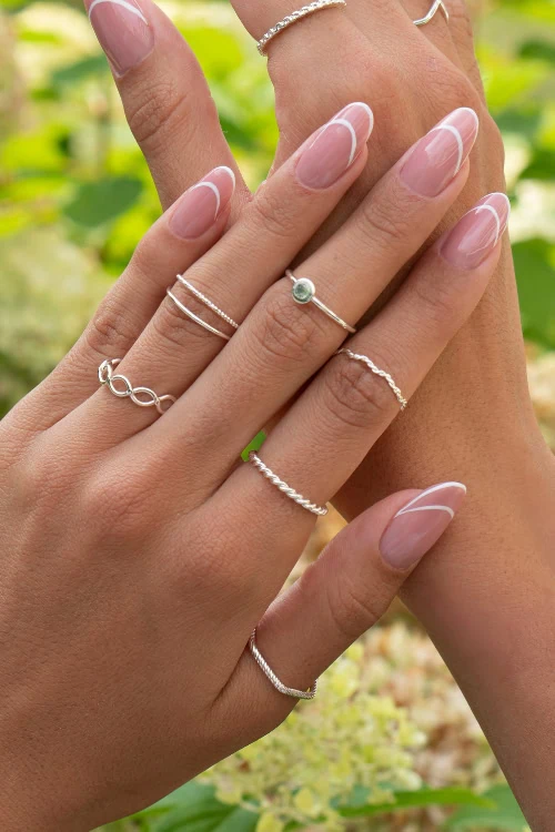 woman's hands with a classy open french manicure