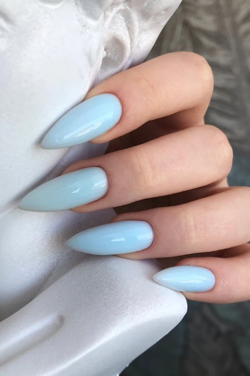 woman's hand with a light blue nail manicure
