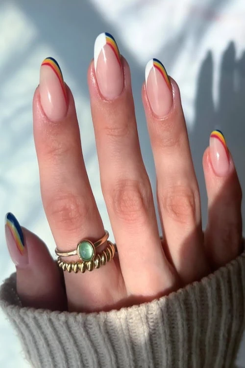 female hand with simple rainbow tip nails