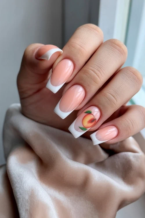 hand with french manicure and peach nail art