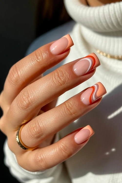 hand with peach nails with swirl abstract design