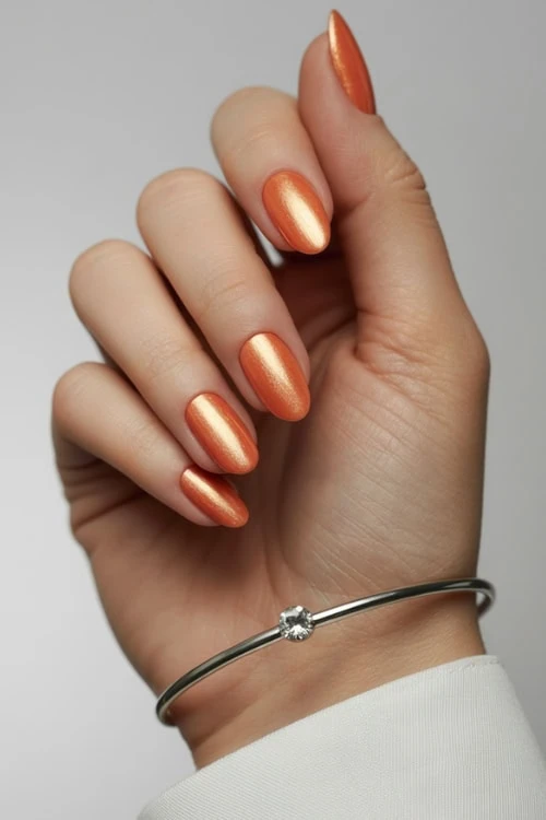 hand with metallic peach nails