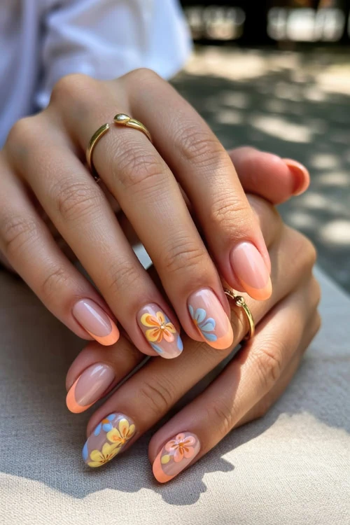 hand with tropical peach nail design
