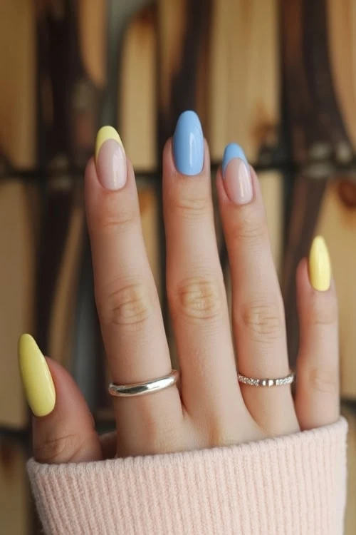 hand with Blue and Yellow Nails Design