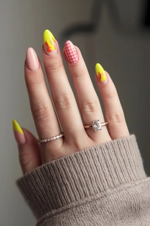 hand with Bright Yellow Nails Design with flames and checkered pattern
