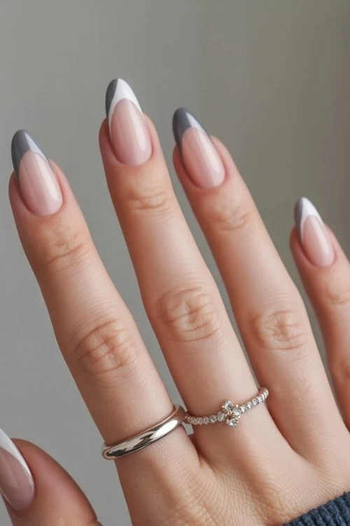 hand with gray and white french tip nails
