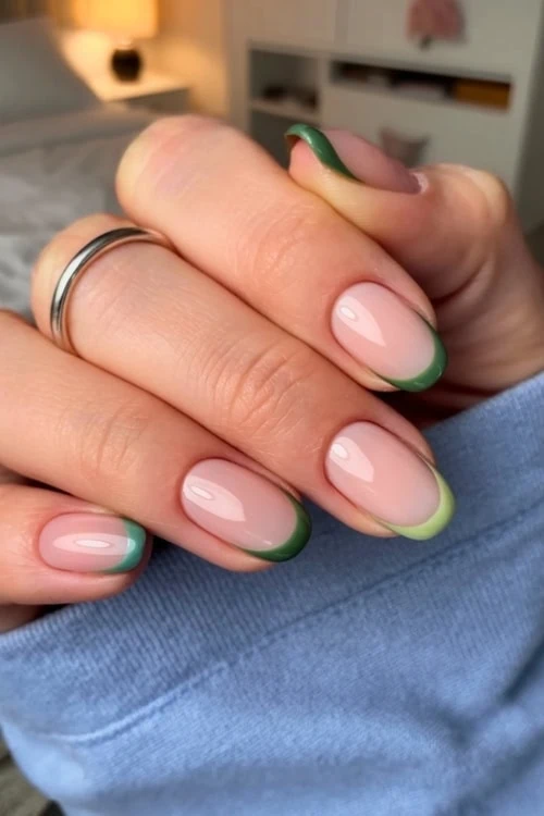 hand with green gradient french tip nails