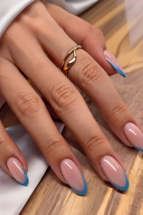 hand with blue french tip nails