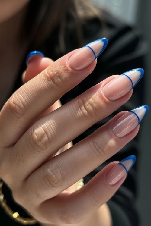 hand with blue negative space french tip nails