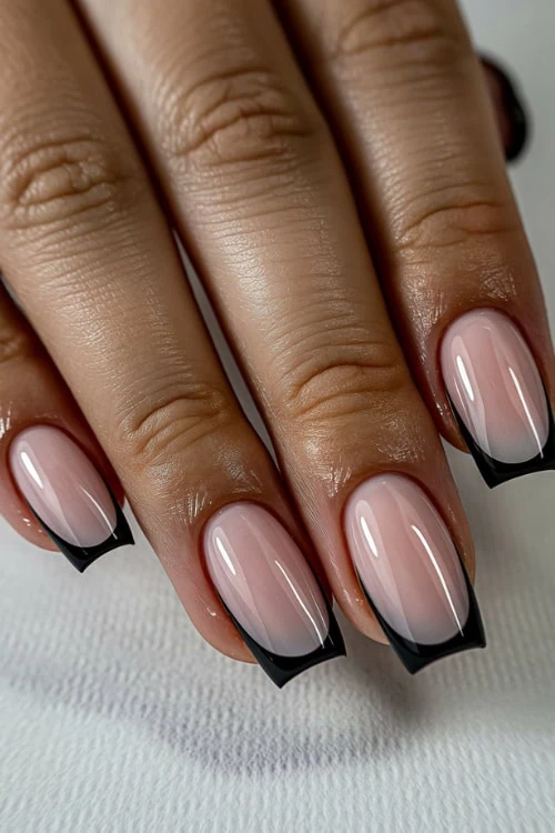 hand with square black french tip nails