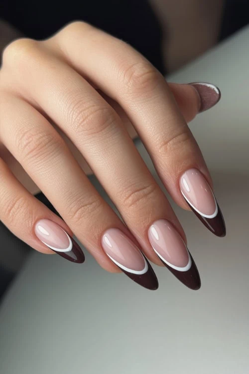 hand with brown french tip nails