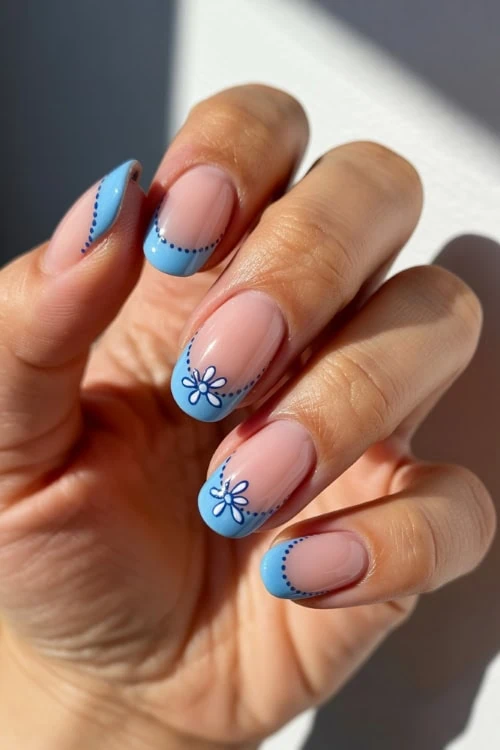 hadn with light blue french tip nails design