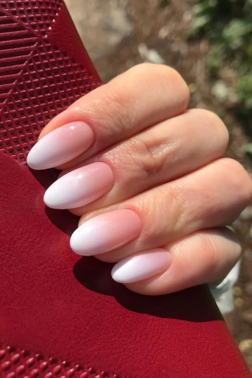 hand with ombre french tip nails