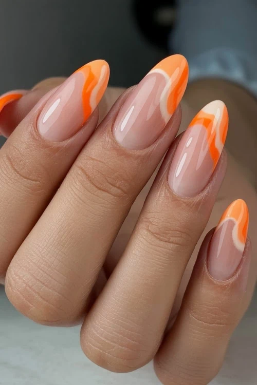 hand with oragne wave french tips