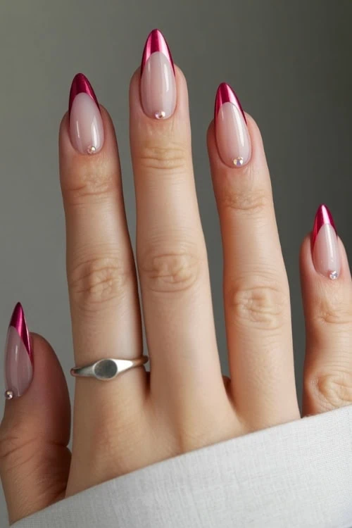 hand with chrome red french tip nails and rhinestones
