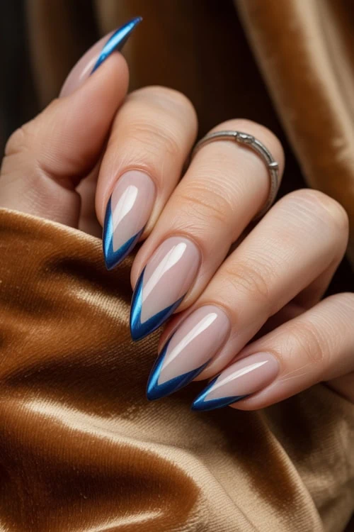 hand with chrome blue v-shaped french tip nails