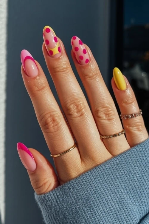 female hand with Pink and Yellow Nails Design
