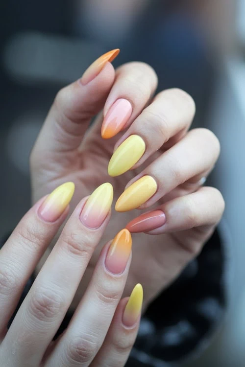female hand with Yellow and Orange ombre Nails Design