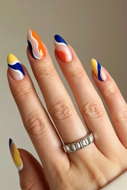 hand with abstract nail design and almond shaped nails