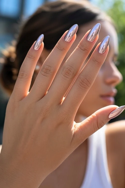 hand with a chrome silver manicure