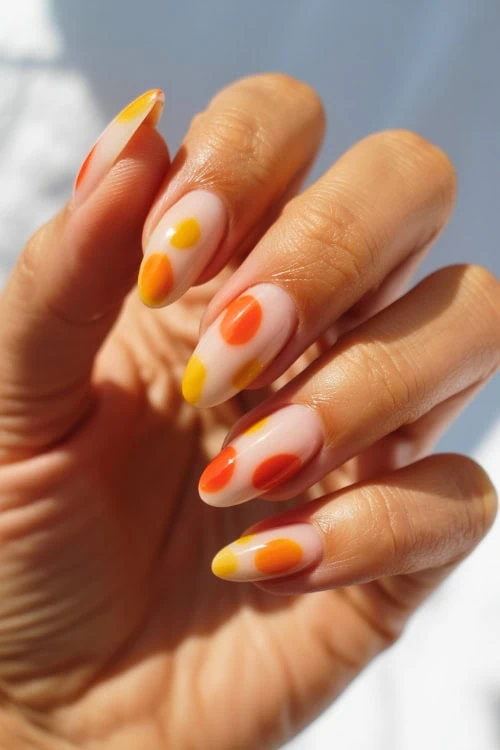 hand with yellow and orange nail art