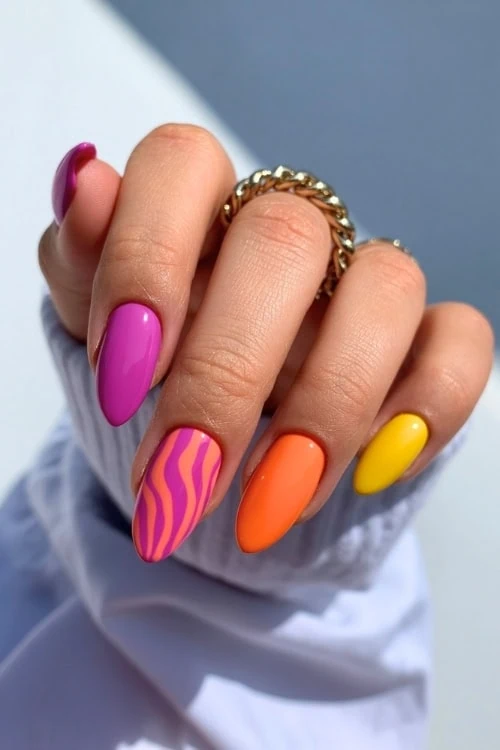 hand with bright multicolored manicure