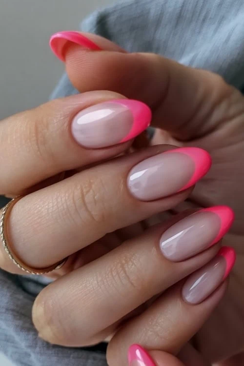hand with bright pink french tip nails